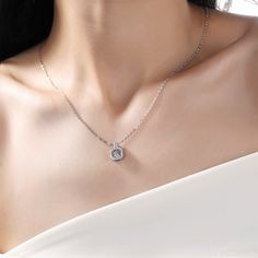 An eye-catching round moissanite dances with ease at the center of this appealing women's necklace, expressing your unstoppable love. Additional round gem set in sterling silver frame the center. Features Moissanite was originally found in meteorites(Chemical name: Silicon Carbide). It was first discovered in 1893, while a scientist was examining meteor samples from a crater in Arizona. After many years, Read Your Heart experts has been recreated moissanite in the laboratory, that make the gemst Anniversary Solitaire Square Pendant Necklace With Prong Setting, Dazzling Lab Grown Diamond Necklaces, Elegant Cubic Zirconia Solitaire Necklace With Square Pendant, Diamond White Square Pendant Solitaire Necklace For Anniversary, Moissanite Necklace With Halo Design In Diamond White, Diamond White Round Pendant Jewelry With Center Stone, Diamond White Jewelry With Center Stone Round Pendant, Formal Moissanite Solitaire Necklace With Round Pendant, Formal Solitaire Moissanite Necklace With Round Pendant