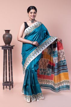 An authentic blue and white handwoven gachi saree with floral and paisley motifs spread all over the body, making it popular among saree lovers. COLOUR: Blue and White CRAFT: Hand block printing DIMENSIONS: Saree length 6.5 Mts., Saree width 1.14 Mts. Blouse piece inclusive. NET QUANTITY: 1 pc saree PATTERN: Floral and paisley motif PRODUCT MATERIAL: Handwoven Gachi Tussar saree PRODUCT TYPE: Saree with Blouse piece WEIGHT: 450 g WASH INSTRUCTIONS: Dry cleaning is recommended for this product. Iron inside out. Do not bleach and expose this product to excessive heat and sunlight for long. Blue Blouse Piece With Printed Border In Traditional Drape, Traditional Blue Blouse Piece With Printed Border, Blue Saree Blouse With Traditional Patterns, Blue Blouse Piece With Kalamkari Print For Festive Occasions, Traditional Blue Pre-draped Saree For Festivals, Blue Art Silk Traditional Wear With Kalamkari Print, Bohemian Style Blue Saree With Traditional Drape, Blue Saree With Traditional Patterns For Festivals, Blue Blouse Piece With Traditional Patterns For Festivals