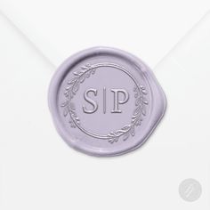 a wax seal with the word sip on it and an ornate wreath around the stamp