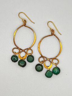 Vintage old brass earring with a beautiful blue green turquoise coin bead dangles. Green Teardrop Brass Jewelry, Artisan Green Brass Earrings, Bohemian Bronze Earrings With Round Beads, Green Brass Drop Earrings, Bohemian Jade Earrings, Nickel Free Bohemian Jade Earrings, Bohemian Nickel Free Jade Earrings, Bohemian Green Wire Wrapped Hoop Earrings, Bohemian Jade Earrings With Ear Wire