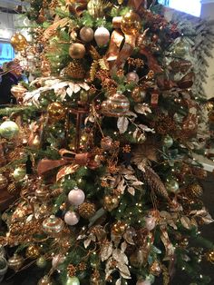 a christmas tree with gold and green ornaments