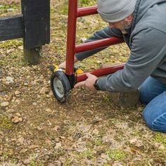 a man is working on a red dolly