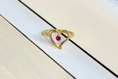 A Vintage 14k Gold Heart Ring Set with Ruby All items are XRay and Acid tested to ensure metal authenticity.  Weight: 3.2 grams Ring Size: 5.5 (resizing available upon request) Classic 14k Gold Heart-shaped Birthstone Ring, 14k Gold Heart-shaped Solitaire Ring, 14k Gold Yellow Gold Solitaire Heart Ring, Formal 14k Gold Heart Ring Stamped 14k, Yellow Gold Rings With Prong Setting For Valentine's Day, Classic 14k Gold Birthstone Ring For Valentine's Day, Yellow Gold Oval Heart Ring For Valentine's Day, Heart-shaped 14k Gold Ruby Promise Ring, 14k Gold Heart-shaped Ruby Promise Ring