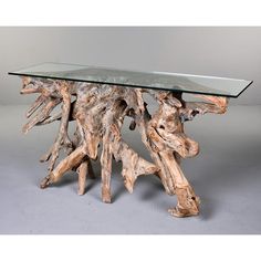 a table made out of driftwood with glass top