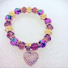 Bracelet Crystal Heart In Purple And Golden.Hand Painted Beads. Very Brilliant! Brand New In Packaging! Very Pretty! Elegant Purple Bracelets With Heart Beads, Purple Charm Bracelet With Colorful Round Beads, Purple Heart Beaded Bracelets, Purple Round Bead Jewelry For Valentine's Day, Adjustable Purple Jewelry With Heart Charm, Purple Adjustable Heart Bracelet For Valentine's Day, Purple Round Beads Jewelry For Valentine's Day, Handmade Purple Bracelets For Valentine's Day, Adjustable Purple Heart Bracelet For Valentine's Day