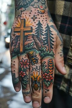 a man with tattoos on his hand and cross