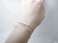 "Double strand beaded bar bracelet - dainty jewelry Tiny baby pink beads beaded on 14K gold filled chain. Double chain bracelet that's femininely dainty in soft shades of gold and blushing pink. measurements bead bar length 1\" please choose length at checkout ♦you can enter shop here! http://etsy.com/shop/illusy" Dainty Yellow Gold Beaded Bracelets In 14k Gold Filled, Everyday 14k Gold Filled Beaded Bracelets With Tiny Beads, Dainty Gold Beaded Bracelets, Dainty 14k Gold-filled Beaded Bracelets, Adjustable Delicate 14k Gold Beaded Bracelet, Delicate Adjustable 14k Gold Beaded Bracelet, Delicate Gold Bracelet With Satellite Chain, Dainty 14k Gold Bracelet With Tiny Beads, Dainty Rose Gold Bracelet, 14k Gold Filled