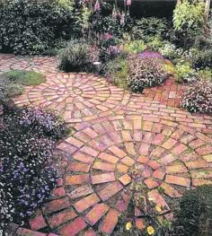 a brick path in the middle of a garden