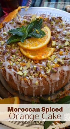 a close up of a cake on a plate with oranges and other food items