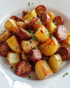 a white plate topped with cooked potatoes and parsley