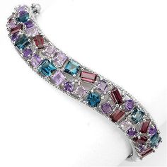 Metal Information: .925 Sterling Silver Setting: Prong Item: Bangle Finish: Rhodium Plated Metal Stamp: 925 Total CTW: 103 28 Carat Bracelet Size: 2.2 Width: 24 mm Stone Information: AMETHYST, RHODOLITE GARNET, LONDON BLUE TOPAZ & IOLITE Shape: OCTAGON, SQUARE & ROUND FACET Stone Size: 3.0 TO 5.0 X 3.0 MM. THIS IS FINE JEWELRY ZirconZ Are High Quality Cubic Zirconia's NEVER BUY A DIAMOND AGAIN PLEASE NOTE: ALL PICTURES ARE CROPPED TO BRING IN DETAILS. Please refer to my sizes listed. ALL Sterling Silver Fine Jewelry Bracelets With Stones, Luxury Sterling Silver Bracelets With Stones, Sterling Silver Multi-stone Bracelets, Sterling Silver Gemstone Bracelet, Multicolor Gemstone Sterling Silver Bracelet, Elegant Multicolor Sterling Silver Bracelet With Stones, Elegant Multicolor Stones Sterling Silver Bracelet, Elegant Multicolor Gemstone Sterling Silver Bracelet, Sterling Silver Multicolor Bracelets For Anniversary