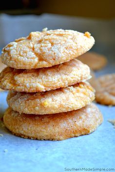 a stack of cookies sitting on top of a blue tablecloth covered in powdered sugar