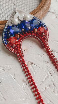 a pair of red, white and blue beaded headpieces on a table