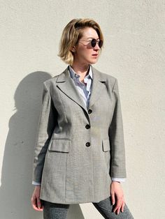 "Vintage Pablo Paris minimalist Dove grey blazer. The blazer is made of blended wool with shoulder pads and brown lining, 3 buttons fastening, two flap pockets and very elegant fit. It easily becomes a timeless item in your wardrobe.  Condition : good vintage condition Label: Pablo Paris Size: 44 Material: 60% wool, 38% polyester, 2% elastane. Lining: 100% acetate Measurements taken lying flat: Shoulders : 43 cm /17\" Pit to pit: 51 cm/20\" Sleeves: 60 cm/23.5\" Length: 76 cm/30\" For more information feel free to contact me." Wool Notch Lapel Blazer Dress For Work, Notch Lapel Blazer Dress With Structured Shoulders For Work, Classic Office Blazer Dress With Structured Shoulders, Classic Blazer Dress With Structured Shoulders For Office, Fall Workwear Blazer Dress With Structured Shoulders, Tailored Wool Blazer Dress For Work, Office Blazer Dress With Structured Shoulders And Suit Collar, Classic Wool Blazer Dress For Work, Wool Blazer Dress With Notch Lapel For Office