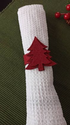 a napkin with a christmas tree cut out on it sitting on top of a table