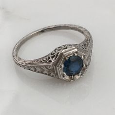 Details: Stunning Art Deco Period platinum and sapphire ring--would make a lovely wedding ring! The center stone is estimated .40 carats, and measures 4.9mm round. The filigree is beautiful on this ring, and is in lovely shape. This is a stunning ring--you will not be disappointed! Please ask all necessary questions prior to placing an order. Measurements: The size is 5 1/2 US and can be sized for a fee. Condition: The overall all condition of this ring is very good. Classic Sapphire Ring In 14k White Gold, Heirloom Solitaire Topaz Promise Ring, Classic Sapphire Halo Ring, Classic Sapphire Birthstone Ring, Round Cut Diamond Ring In Platinum, Platinum Diamond Ring With Round Cut Gemstone, Timeless Sapphire Ring Gift, Heirloom Solitaire Topaz Ring For Formal Occasions, Brilliant Cut Sapphire Diamond Ring In Platinum