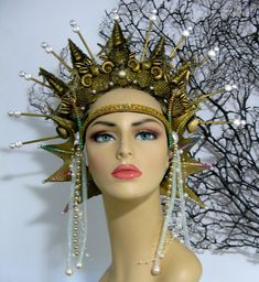 Mermaid Queen Headpiece, it is handmade piece with the ears attached. The headpiece is decorate with pearls, gold paint, gold glitter, light weight shells, gold beads, metallic trims, decorative rhinestones and crinoline tubes. Any question let me know  Thank you Gold Tall Crown Costume Hats And Headpieces, Gold Headpieces For Costume Party And Carnival, Fantasy Headpieces For Mardi Gras Costume, Whimsical Headpieces For Festivals And Parties, Unique Handmade Headpieces For Costume Party, Gold Adjustable Costume Hats And Headpieces, Fantasy Gold Costume Hats And Headpieces For Masquerade, Fantasy Tall Crown Costume Hat For Festival, Fantasy Costume Hat With Tall Crown For Festivals