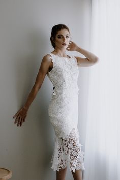 * Ivory Guipure Lace * Square Neckline * Deep V back * Midi Length * Black Satin Bow adornment in back * Zipper closure * Floating Lace pieces * Fully Lined Size Chart: *Bust: 32-34 inches *Waist: 25-26 inches *Hips: 35-36 inches Elegant Wedding Gown With Delicate Lace, White Sleeveless Gown For Ceremony, Elegant Fitted Wedding Dress With Lace Back, Elegant Lace Wedding Dress With Lace Back, Elegant Floor-length Wedding Dress With Lace Back, Wedding Night Gown With Scalloped Lace And Fitted Bodice, Lace Back Gown With Fitted Bodice For Bridesmaids, Wedding Evening Dress With Sheer Back And Fitted Bodice, Elegant Lace Gown With Sheer Back