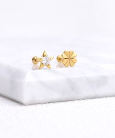 Introducing our Shining Star Stud earrings, perfect for adding a touch of cuteness to any outfit. Inspired by the starry sky, these earrings will add a touch of sophistication to your look. Be the shining star wherever you go. ✨ Detail： -Post material: gold plated with internal stainless steel or stainless steel. Cubic Zirconia -Gauge: 16g | 1.2mm-Post length: 6mm-Dimensions: 6.4mm Length x 6.7mm Width -Include: single item -Closure: screw ball back * Shop extra ball backing here. * Piercings ar Gold Star Cartilage Earrings, Gold Star Cartilage Earrings For Pierced Ears, Gold Star Shaped Pierced Cartilage Earrings, Elegant Star Charm Cartilage Earrings, Elegant Star Shaped Cartilage Earrings With Star Charm, Gold Piercings With Star Charm As Gift, Celestial Star-shaped Piercings For Gifts, Celestial Star Piercings Gift, Celestial Star-shaped Piercings As Gift