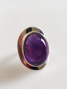 Gorgeous African Amethyst Ring Made with Sterling Silver Handmade Ring Made in india Ring Gemstone Size: 20x16 MM Top Quality Natural Amethyst Ring made with Sterling Silver 925 lovely Ring Very comfortable Ring Purple Oval Cabochon Hallmarked Ring, Purple Amethyst Oval Cabochon Ring, Amethyst Ring With Large Stone, Purple Amethyst Ring With Polished Finish, Purple Oval Stone Setting Rings, Purple Oval Cabochon Ring For Gift, Purple Oval Ring With Stone Setting, Spiritual Oval Amethyst Ring With Stone Setting, Purple Oval Stone Set Ring