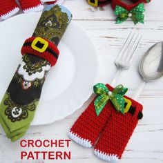 a crochet christmas stocking on top of a plate next to silverware