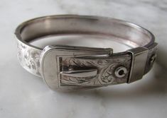 Bangle  Code AA1E A Beautiful  Sterling Silver Bangle in an engraved Buckle Design with a plain back  Width 1.2cms Wide - 6cms inside closed wide - I Have a 16.5cms wrist and it fits me just right  Approx 19gms  In Good Condition  Stamped  " Chester 1938 JH&S " Other Bracelets not included Ornate Stamped Bracelets For Formal Occasions, Antique Stamped Cuff Bracelet For Formal Occasions, Antique Engraved Cuff Bracelet For Formal Occasions, Antique Engraved Sterling Silver Bracelet For Formal Events, Victorian Sterling Silver Bracelet, Engraved For Formal Occasions, Adjustable Engraved Bangle For Formal Occasions, Antique Sterling Silver Etched Bracelet For Formal Occasions, Antique Etched Sterling Silver Bracelet For Formal Occasions, Adjustable Engraved Victorian Bangle