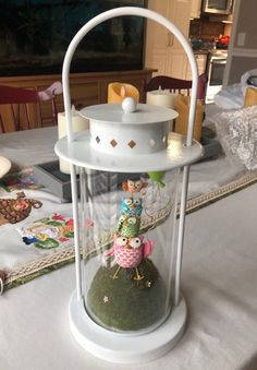 a white lantern sitting on top of a table