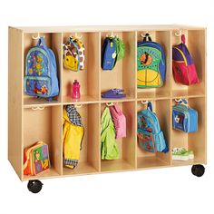 a wooden toy storage unit filled with backpacks and bookshelves for children's toys