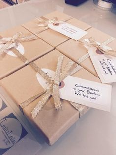 two brown boxes with tags on them sitting on a table