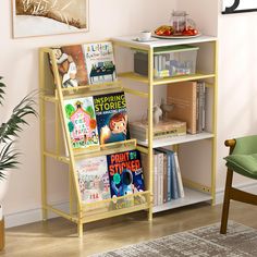 a yellow book shelf filled with books next to a green chair and potted plant