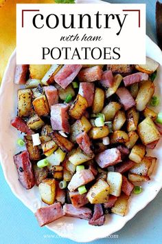 a white plate topped with potatoes and ham