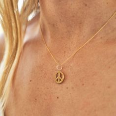 The Story A timeless symbol, The F&B Peace Sign Charm Necklace is as classic as they come. Since the 1950s the "peace sign" has been a beacon of hope and harmony. Used by anti-war activists all over the world, the peace sign is just as relevant today as it was then. Handmade here in LA from 14 karat rose, yellow, and white gold, the open design allows your skin to show through while sitting flat against the chest. Not too small and not too big, it is the perfect size for everyday wear. With its Gold Jewelry With Peace Sign For Gift, Cheap Adjustable Jewelry With Peace Sign, Vintage Jewelry With Peace Sign As Gift, Vintage Jewelry With Peace Sign For Gift, Symbolic Peace Sign Jewelry For Gift, Spiritual Peace Sign Necklace As A Gift, Gold Peace Sign Jewelry Gift, Symbolic Round Peace Sign Jewelry, Vintage Peace Sign Jewelry Gift