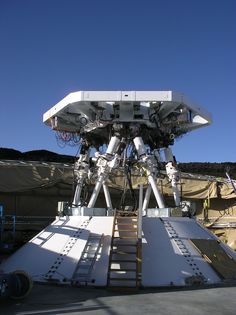 the large telescope is attached to the side of the building with ladders on it