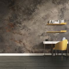 a desk and chair in front of a wall that has a gray marble pattern on it