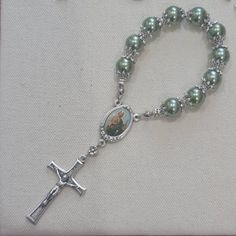 "Lovingly hand-made, high-quality Catholic mini rosaries. Perfect giveaways for your little tot's baptism. These also make meaningful wedding keepsakes... a token of gratitude to the guests who'll join your family celebration.  A universal gift for everyone who'll join you in any of your Christian events. The pocket rosary is made of glass pearls in 10mm size, carefully threaded with a beading wire and secured with metal stoppers for durability. The rosary centre and crucifix are made in Italy. Silver Beads Rosary As Gift, Dainty Silver Rosary Gift, Handmade Adjustable Rosary For First Communion, Handmade Rosary Bracelet With Round Beads For Baptism, Handmade Silver Rosary Bracelet For First Communion, Handmade Silver Rosary Bracelet For Baptism, Handmade Silver Rosary For Baptism, Silver Rosary For Baptism, Hand-strung Rosary As A Gift