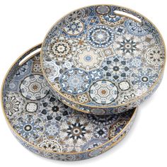 three blue and white plates stacked on top of each other, one with an intricate design