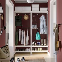 an organized closet with shoes and clothing hanging on the rack, along with other items