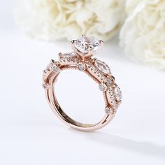 She is the type of person that makes forever seems too short. Treat beloved her to this stunning ring that celebrates your endless love and passion. This design features a shimmering round cut stone at the center, while marquise cut stones and additional round stones decorate the twisting shank. With rose gold color and milgrain on the shank,this ring shows a really elegant and exquisite on her finger. Carat Weight: 2.5 ctStone Size: 7 mmStone Type: Jeulia® StoneNumber of Stones: 1 Stone Color: Diamond WhiteStone Shape: RoundCarat Weight: 0.933 ctStone Size: 1.1,1.5,2,3*1.5 mmStone Type: Jeulia® StoneNumber of Stones: 63 Stone Color: Diamond WhiteStone Shape: Round, MarquiseWeight: 5.1 gWidth: 6.44 mmHeight: 8.32 mmThickness: 2.46 mmMaterial: 925 SilverPlating Color: Rose Gold Rose Gold Flower Ring With Center Stone For Promise, Cubic Zirconia Halo Ring With Marquise Cut For Wedding, Elegant Marquise Diamond Promise Ring, Halo Setting Marquise Cut Wedding Ring, Marquise Cut Bridal Set With Prong Setting For Promise, Dazzling Rose Gold Crystal Ring For Wedding, Marquise Cut Bridal Sets For Promise Ring, Marquise Cut Moissanite Halo Ring For Anniversary, Elegant Marquise Cut Bridal Sets For Promise