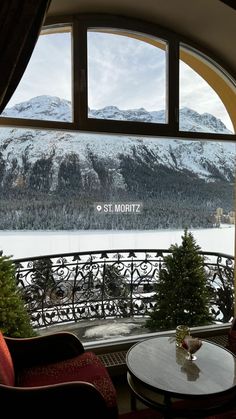 there is a view out the window of a hotel room with mountains in the background