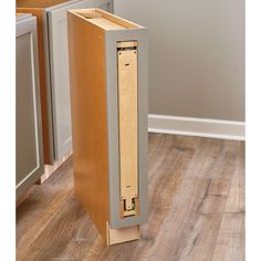 an empty cabinet in the middle of a kitchen floor