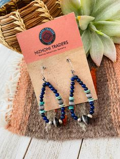 New without tags BRAND : Nizhoni Traders LLC JEWELRY TYPE : Earrings TYPE : Earrings STYLE : Dangle METAL : Sterling Silver MAIN STONE : Lapis Lovely Handmade Turquoise, Lapis and Sterling Silver Beaded Dangle Hoop Earrings. Such beautiful craftsmanship! These measure 2 1/4 inches long and 1 inch wide. Stones are natural and will vary. Thank you for checking out my store. Please contact us with any questions. 4/25/23 bin 28 Traditional Earrings With Round Natural Stones, Traditional Earrings With Natural Stones, Bohemian Sterling Silver Teardrop Beaded Earrings, Bohemian Blue Beaded Earrings With Natural Stones, Southwestern Dangling Beads Earrings Gift, Southwestern Style Dangling Beads Earrings As A Gift, Southwestern Style Dangling Beads Earrings For Gift, Southwestern Style Earrings With Dangling Beads For Gift, Southwestern Dangle Beaded Earrings As Gift