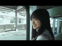 a woman is looking out the window of a train