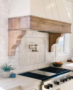 a stove top oven sitting inside of a kitchen