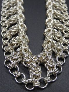 18.5" Byzantine Weave Necklace Sterling Silver, w/ Sterling Silver Lobster Clasp Top Strand - 3.5mm, 15 gauge rings 36 Triple Byzantine Weaves of 2.5mm rings holding bottom strand of 4mm, 18 gauge rings with 2 rings of 2.5mm, 20 gauge rings between each A welder by trade, I have recently found a passion for creating wearable pieces of jewelry that have a timeless beauty and elegance. All of my pieces are hand-fabricated our of sterling silver, or gold-plated, jus rings using traditional metalsmi Jump Ring Chain Link Jewelry For Jewelry Making, Sterling Silver Byzantine Jewelry With Silver Chain, Silver Byzantine Sterling Silver Necklace, Byzantine Style Jewelry With Box Chain Link, Byzantine Style Silver Chain Jewelry For Gifts, Byzantine Style Silver Chain Jewelry Gift, Silver Byzantine Necklace, Byzantine Chain Jewelry As Gift, Byzantine Chain Jewelry For Gifts