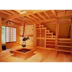 an empty room with wooden floors and shelves