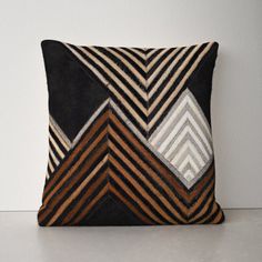 a black and brown pillow sitting on top of a table