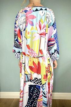 Beautiful handmade vintage / Boho style kimono robe, ideal for fashion at home or wear over jeans & tee. Beach cover up, multi coloured Art print design.Lovely, floaty, soft silky fabric, ideal for covering up on the beach or throw over pyjamas. Pretty multi colour design, features flowers, ladies faces, and modern art styling. Free size fits from UK size 8 to size 16machine washable Printed Beach Dress For Spring Holiday, Tropical Multicolor Dress For Day Out, Multicolor Graphic Print Dress For Spring, Fun Floral Print Vacation Dress, Multicolor Graphic Print Dress For Vacation, Multicolor Graphic Print Dress For Day Out, Vacation Dresses With Multicolor Graphic Print, Multicolor Graphic Print Vacation Dress, Long Sleeve Beach Dress With Abstract Print