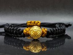 Gift yourself or your love once this Unisex Money Ball Bracelet. Crafted with 24 Karat Gold amd Mandala String. *Karat: Au999 Pure Gold *Gold Color: Yellow *Gold Weight; 1.63grams *LENGTH: Adjustable *Band Width: 10.4mm *Money Ball Size: 14.1mm *Real 24K Gold. NOT gold filled. NOT gold Plated. Pls message us if you want to customize your bracelet a certain way and we'll be happy to help you 💥PLS FOLLOW US AND CHECK OUR OTHER LISTINGS. WE HAVE NEW STOCKS LISTED DAILY/WEEKLY. 📬S H I P P I N G WE Adjustable Round Bracelets For Puja, Adjustable Bracelets For Puja, Adjustable Gold Wristband With Round Beads, Gold Spiritual Wristband With Round Beads, Adjustable Gold Bracelet For Ceremonial Occasions, Gold Adjustable Spiritual Wristband, Adjustable Gold Spiritual Wristband, Traditional Adjustable Gold Braided Bracelets, Gold Braided Bracelets With Jubilee Design And Round Beads