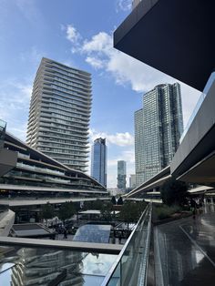 the city skyline is seen from an elevated walkway