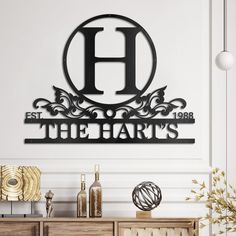 a metal sign that says the hart's on top of a cabinet in front of a white wall